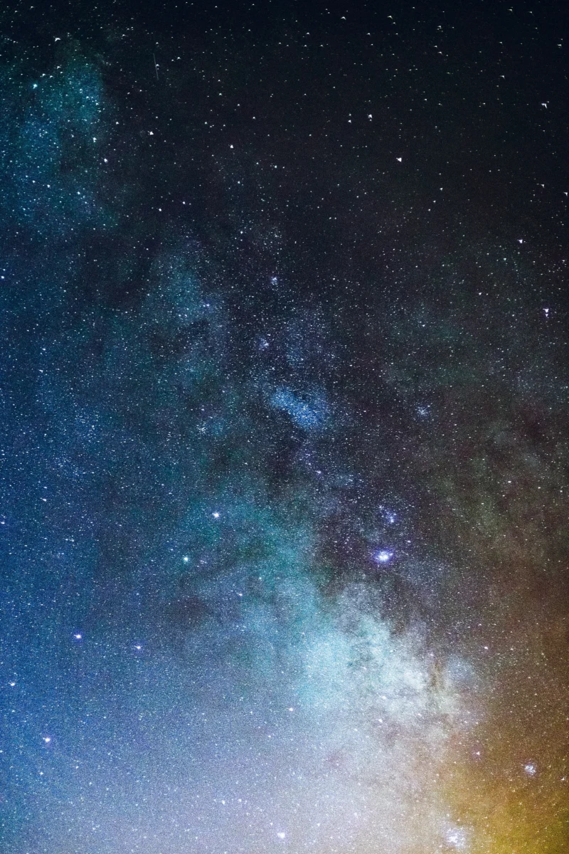 Milky Way galaxy night time space wallpaper in 4K resolution with vivid purple and blue colors for AMOLED mobile and desktop screens.